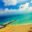A breathtaking aerial view of a vibrant beach in Cancun, featuring golden sands and turquoise waters.